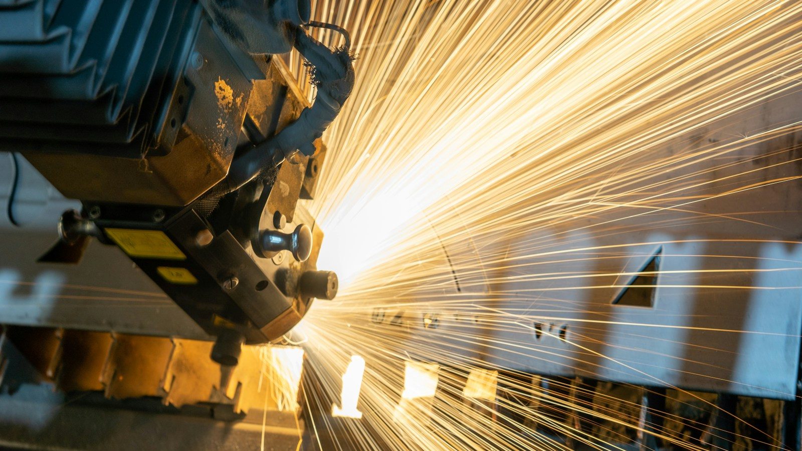 man in blue jacket standing beside brown wooden post